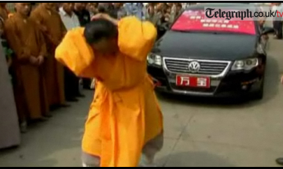 Buddhist pulls cars with her hair